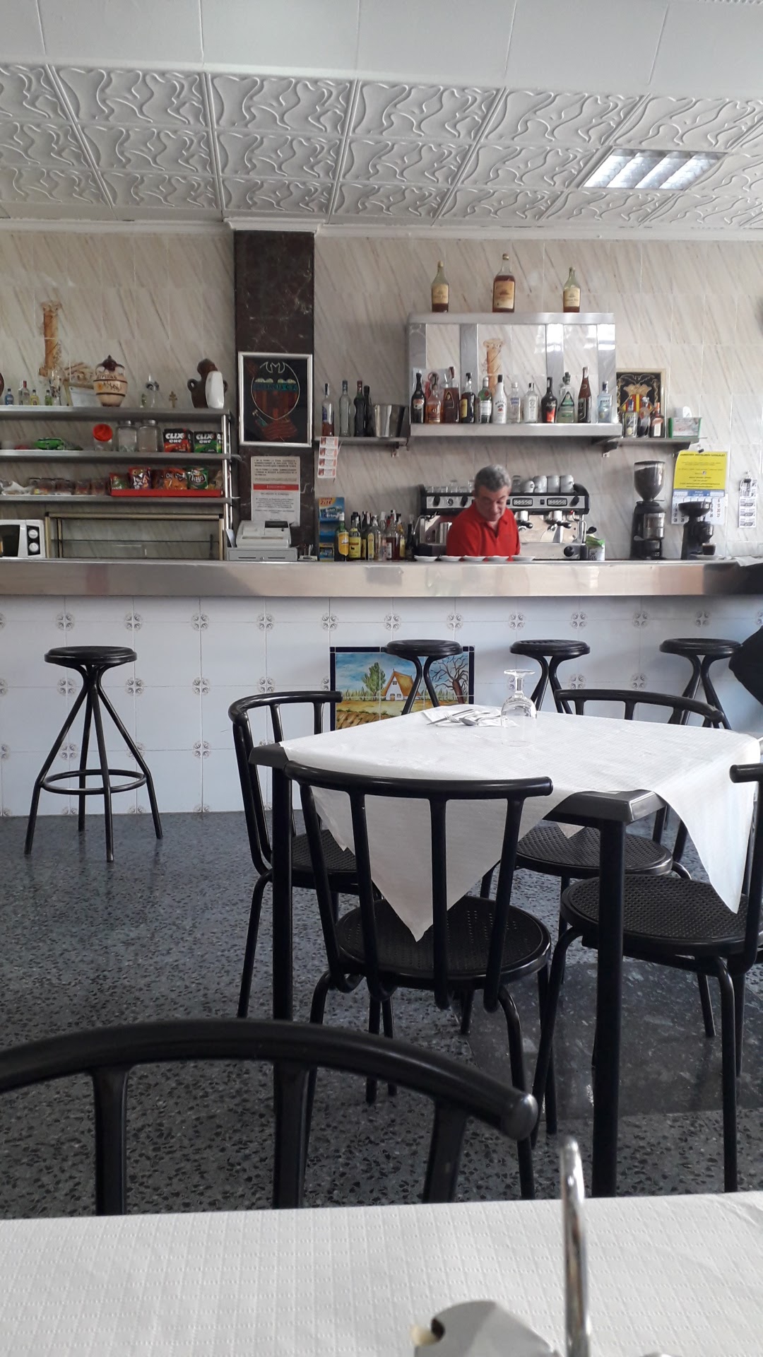 Interior del Restaurante Amanecer con mesas y barra