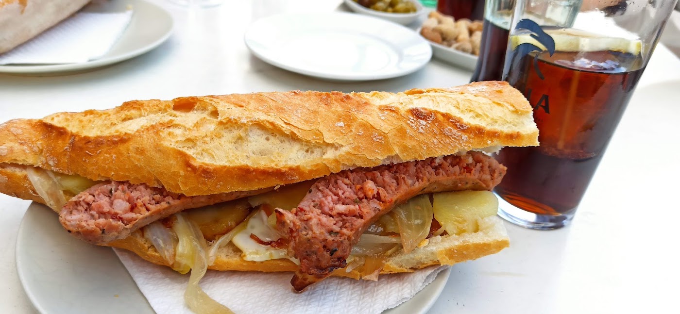 Bocadillo con vaso de bebida en el Restaurante Amanecer